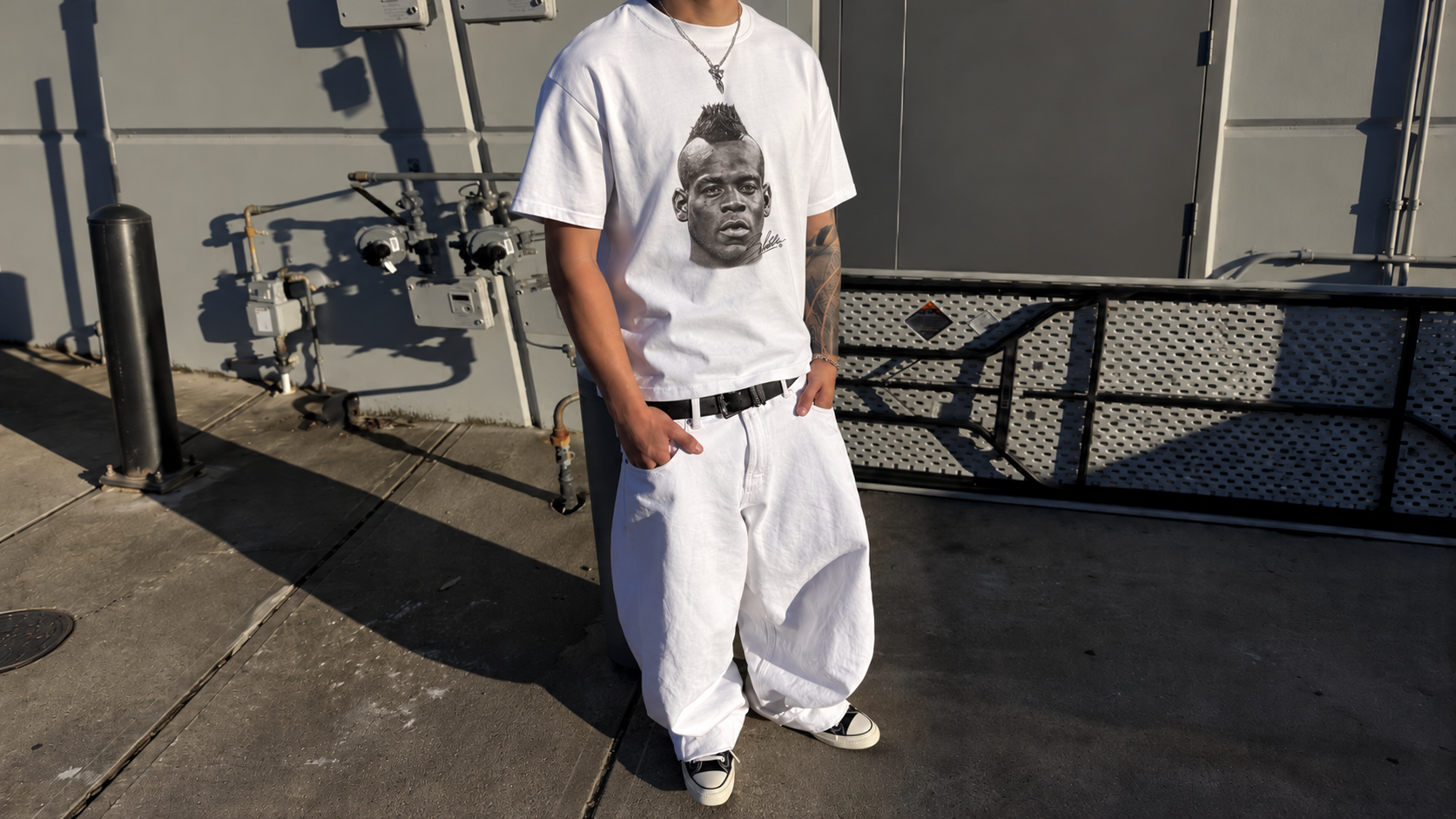 Model in front of a grey wall wearing a JØGA front portrait tee