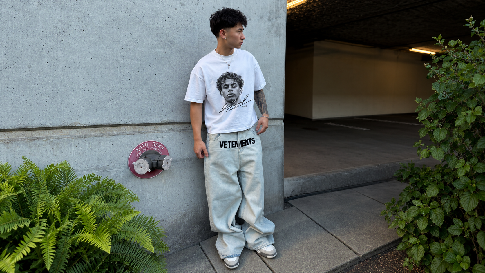 Model in a parking garage wearing a JØGA front portrait tee