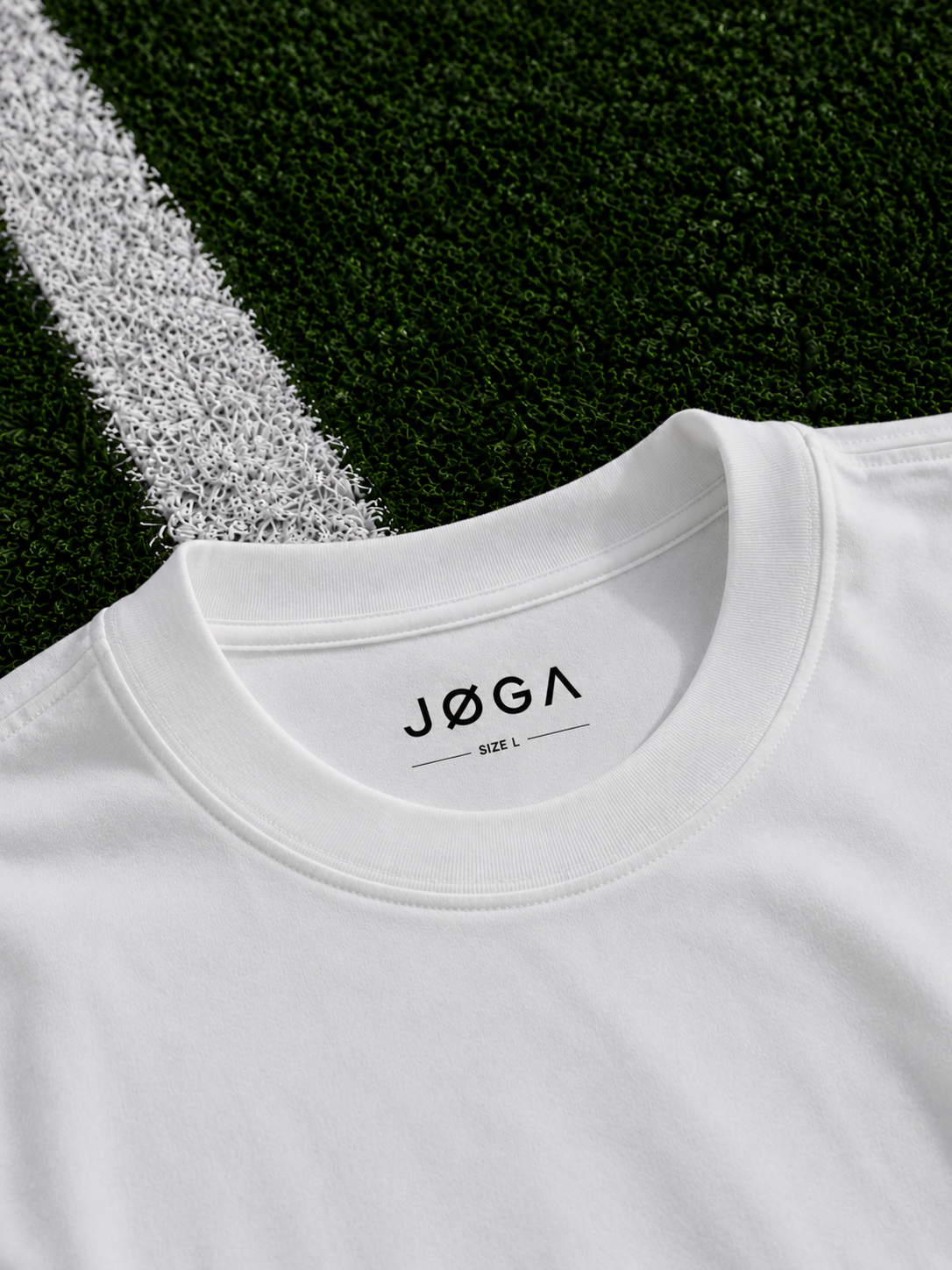 Close-up of the JØGA chest logo on white fabric