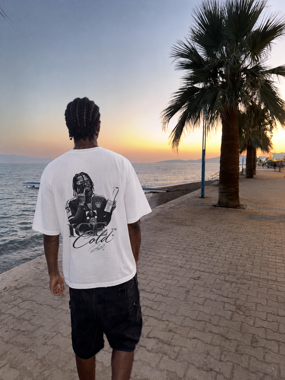 Model wearing the Joga Bonito tee by the pool at night