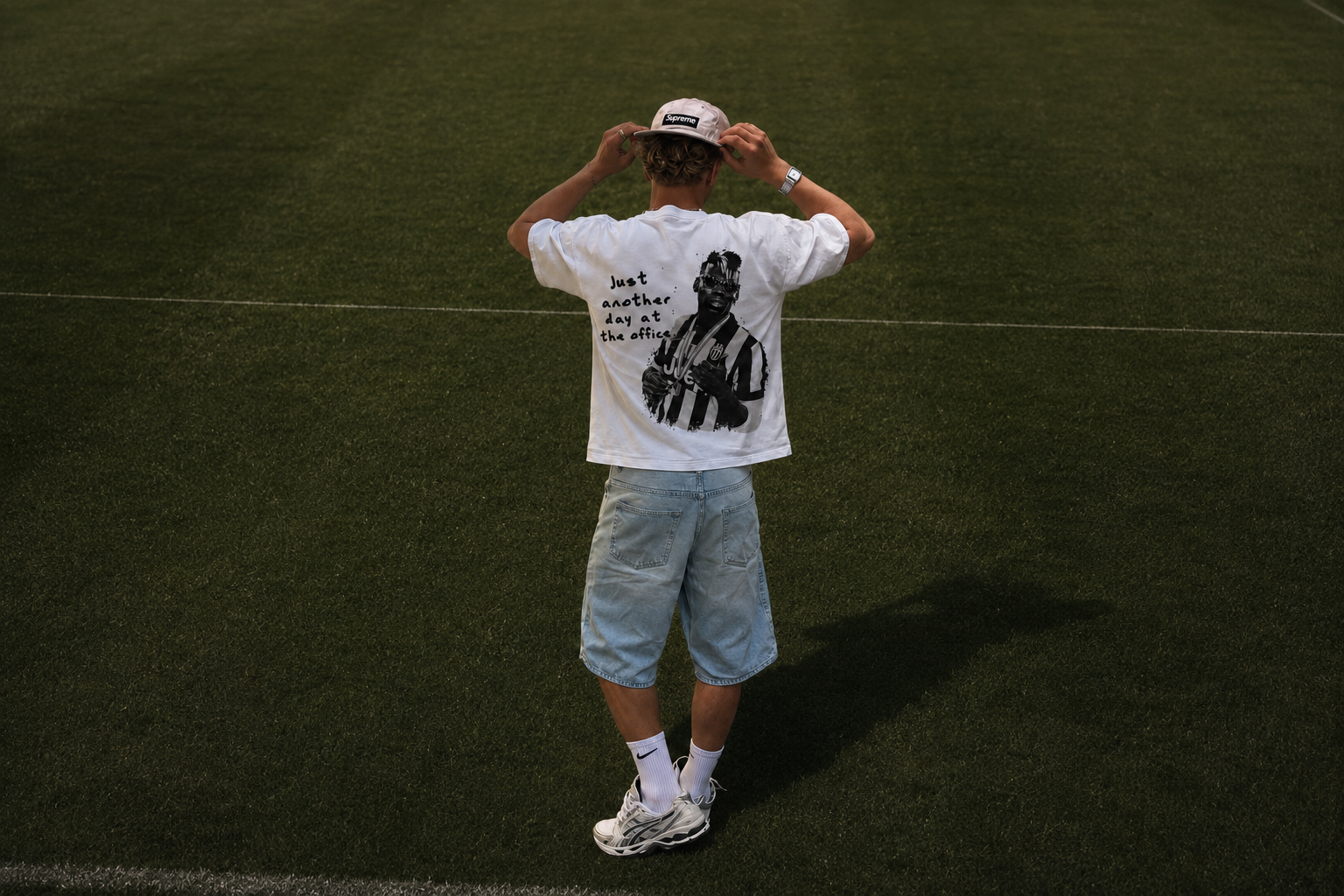 Model on the pitch wearing the Day At The Office tee