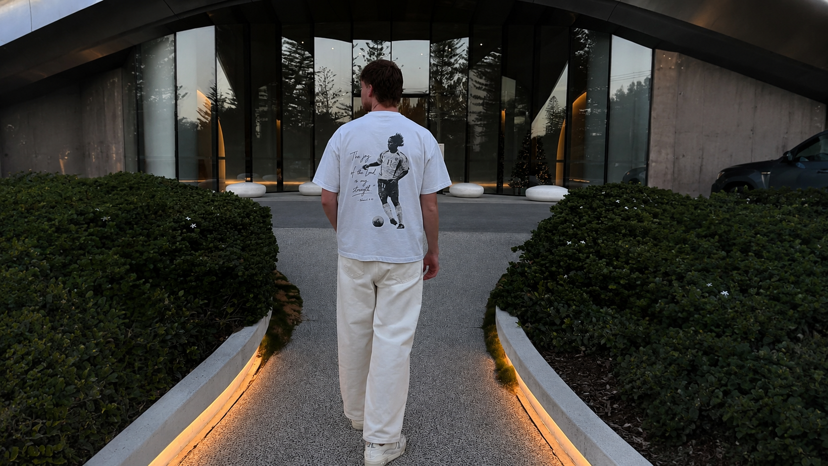 Model at dusk wearing the Joy Of The Lord tee