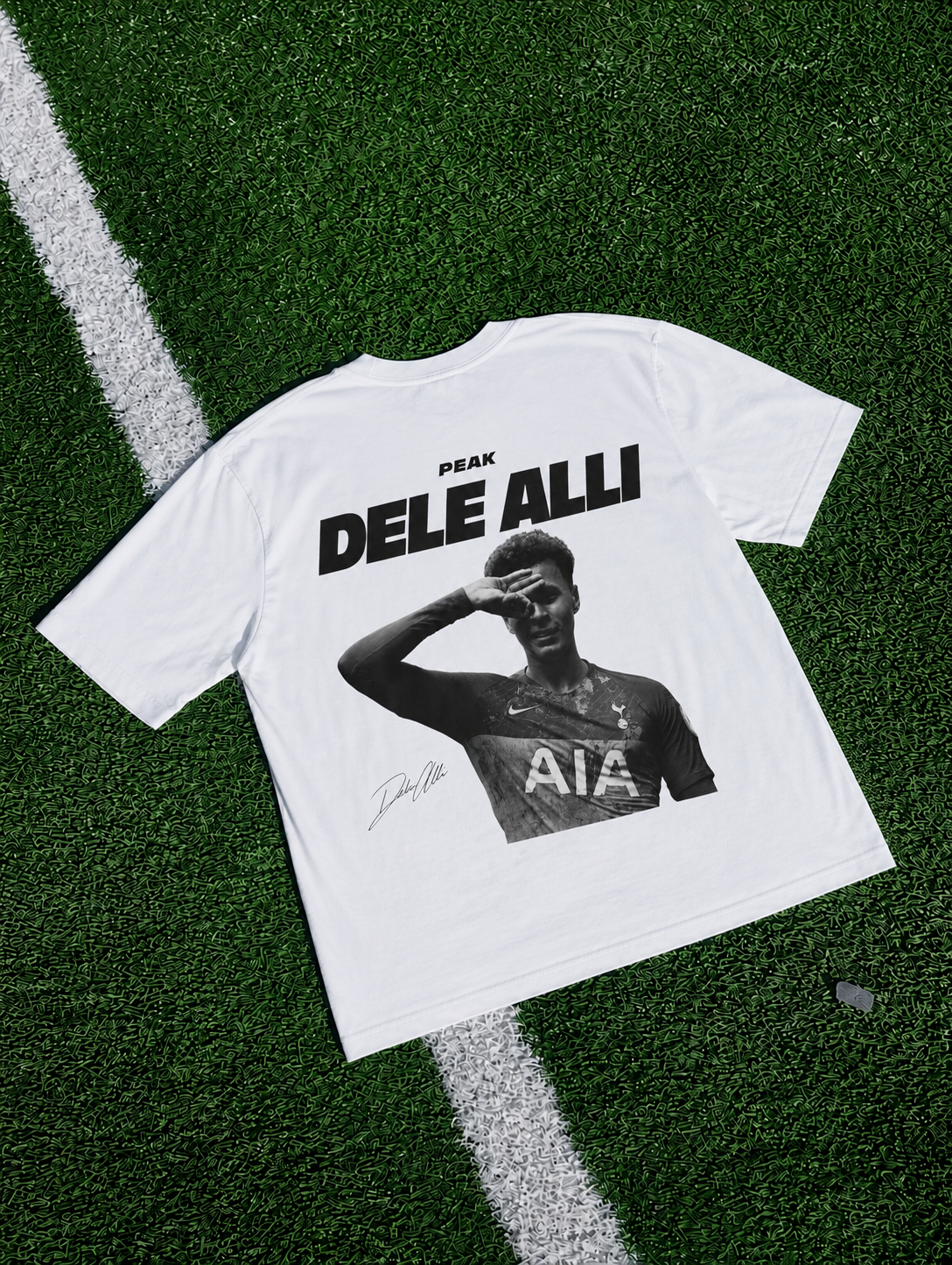 Dele Alli Peak T-shirt in white featuring a black and white football design on artificial turf