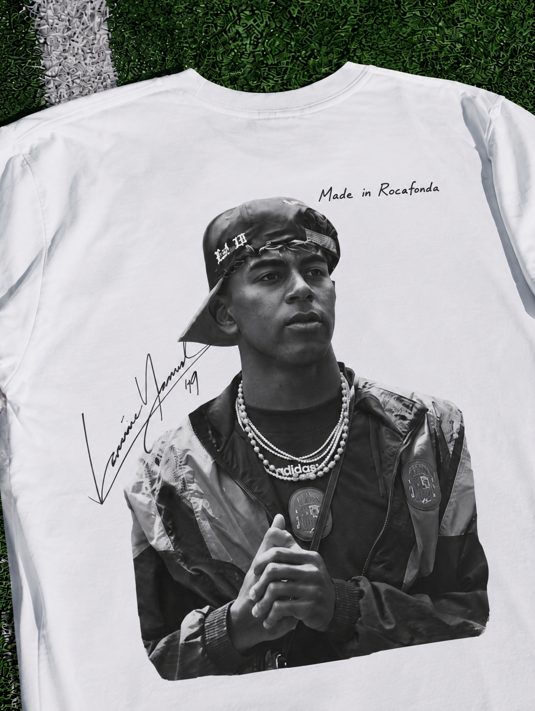 Lamine Yamal Made in Rocafonda T-shirt in white featuring a black and white football portrait on artificial turf zoomed in