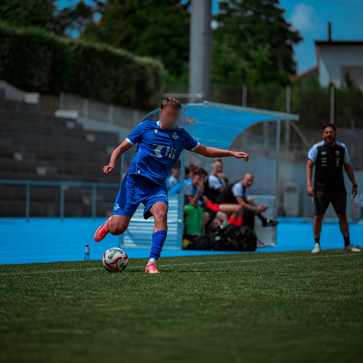 Player mid-stride about to strike the ball during a match